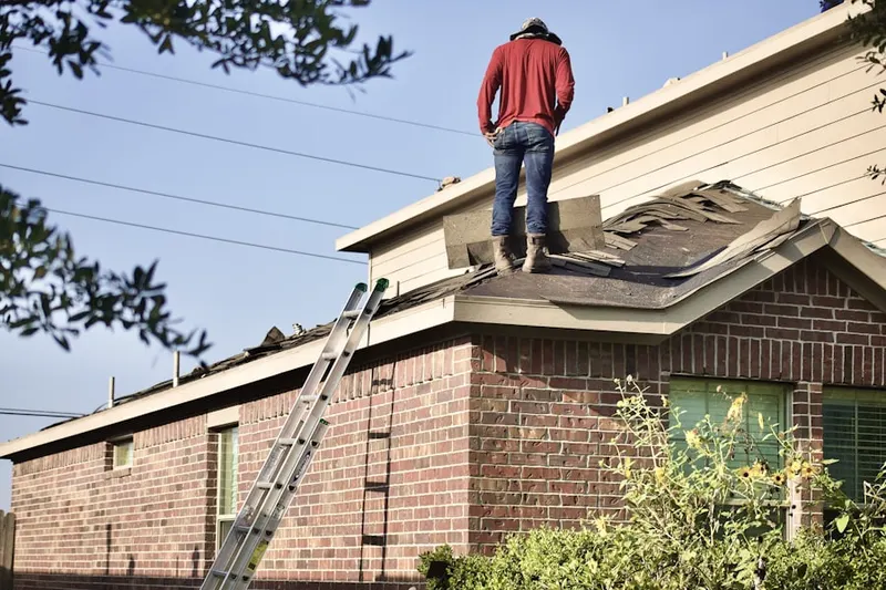 Professional roofer working on a residential roof in Lost Forest